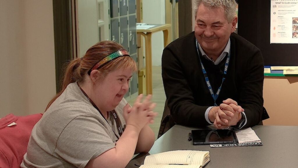 Woman and man chat at a table as part of a Winter Engagement Fund event