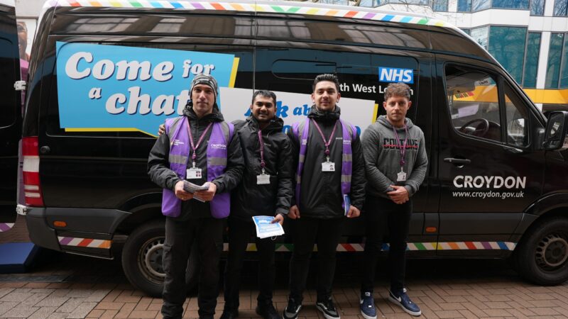 Four vaccinators standing outside the Croydon vaccination van